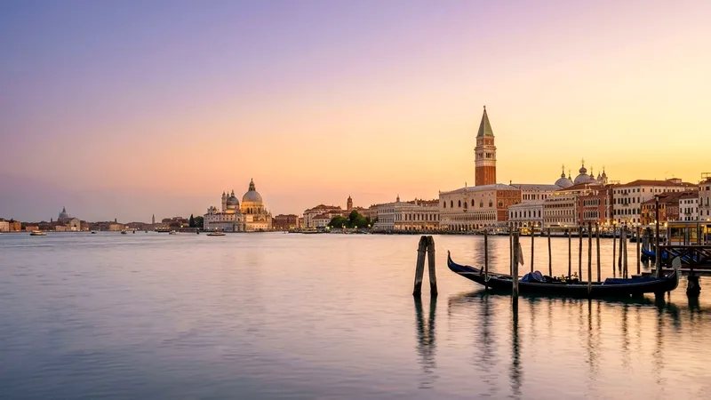 Venice lagoon at sunset with Doge's Palace, Campanile and Salute dome on the right.